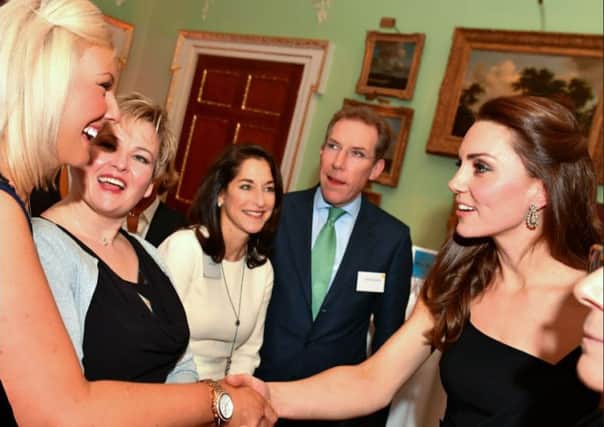 Joy Hodgkinson (left)  from Cotsford Junior School meets the Duchess of Cambridge.