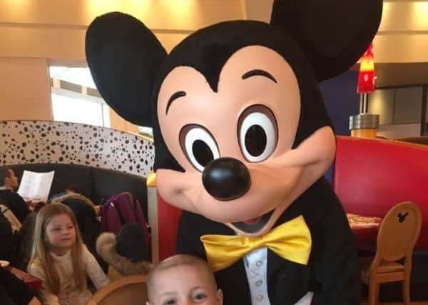 Bradley Lowery meets Mickey Mouse on his dream Disneyland trip.