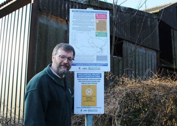 Pictured alongside one of the new signs is Chris Scaife, Hartlepool Borough CouncilÂ’s Countryside Access Officer.
