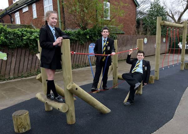 Former members of  Eldon Grove primary school council (left to right) Amelia Ward, Isaac Organ and Harry Siddle playing on the climbing frame they oversaw.