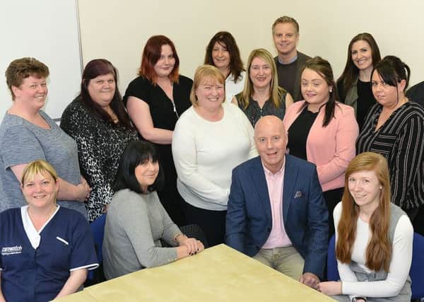 Michelle Banks (Care Manager) (front second left) and Steve Doughty (Director) (front third left) with members of Carewatch staff. Picture by FRANK REID
