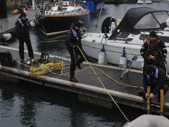Police divers search the marina at the weekend