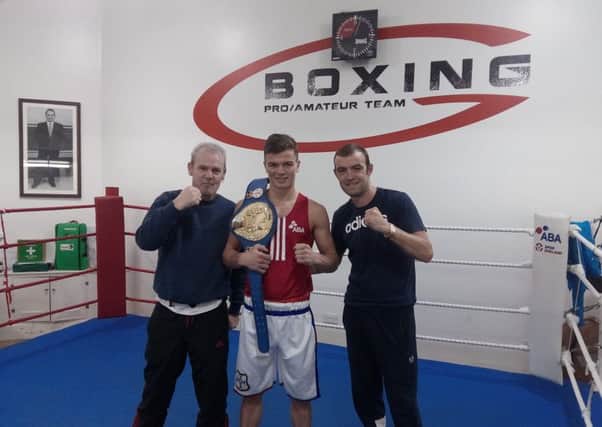 Gus Robinson Developments ABC coaches Tony Martin (left) and Dave Robson (right) with their champion, Luke Cope