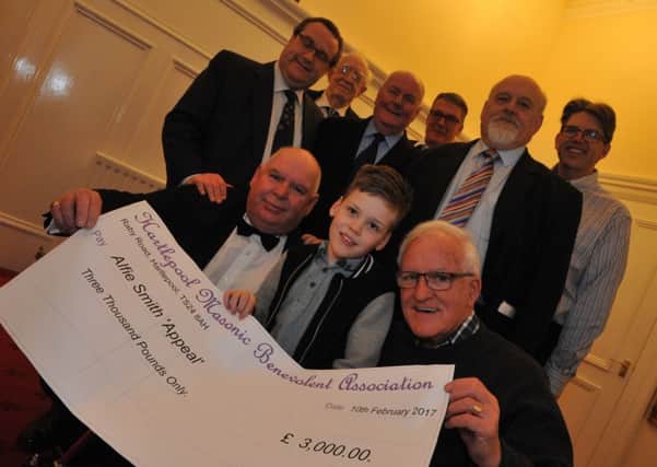 Alfie Smith receives a cheque for Â£3,000 from Hartlepool Freemasons.