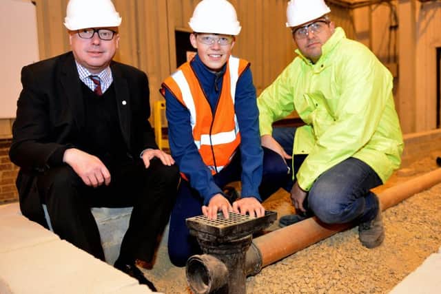 MP Grahame Morris (left) photographed with trainee Kieran Blackmore (centre) and Phil Brown construction manager during his  visit to Profound Services. Picture by FRANK REID