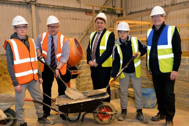MP Grahame Morris (2nd left) photographed with (left to right) trainee Jason King, managing director Steven Ward trainee Kieran Blackmore, and Phil Brown construction manager during his  visit to Profound Services. Picture by FRANK REID