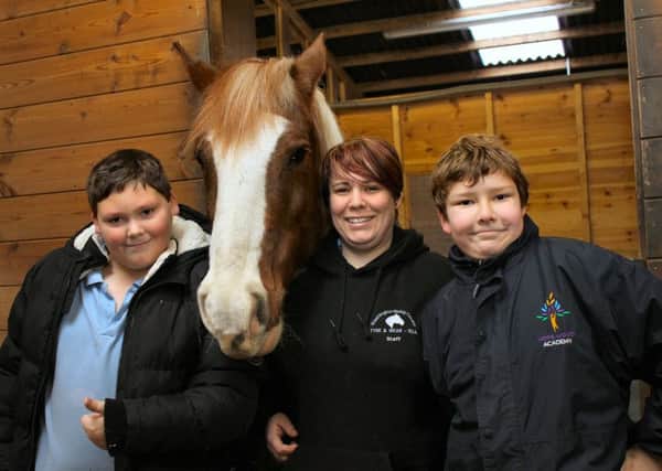 Helping out in the stables Hope Wood Academy students, left, Harry Hudson, 10, Tom Paylor-Bent, 10 and Washington Riding Centre education support officer Tracy Steel with Archie the horse.
