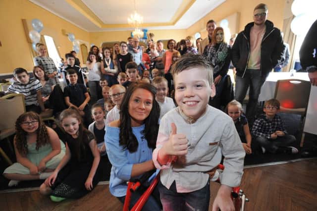 Alfie Smith and mum Annie are surprised by friends at the Staincliffe Hotel, to help celebrate his fund reaching it's Â£50k target and to announce the date for his operation.
