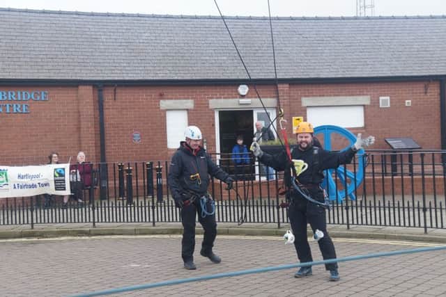 Barry Currell touches down after abseiling down the Transporter Bridge