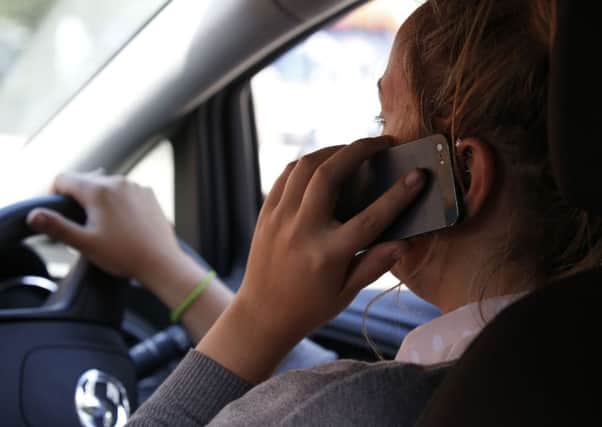Police are clamping down on drivers who use their mobile behind the wheel