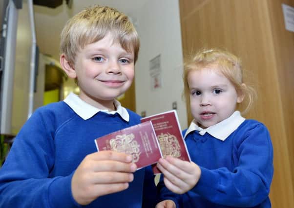Pupils from Eldon Grove Academy Samuel Bousfield and Scarlett Herring with their passports.