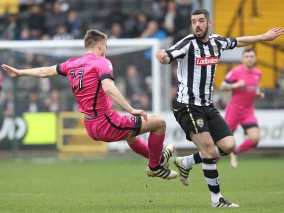 Rhys Oates jumps into a challenge with Richard Duffy at Meadow Lane