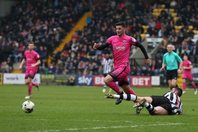 Padraig Amond skips out of challenge from Notts County's Richard Duffy