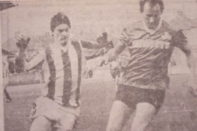 Paul Dobson tries to win possession from the York player-manager Denis Smith.