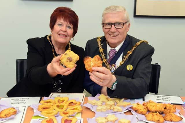 Mayor and mayoress Coun Rob and Brenda Cook judge the biscuit baking competition