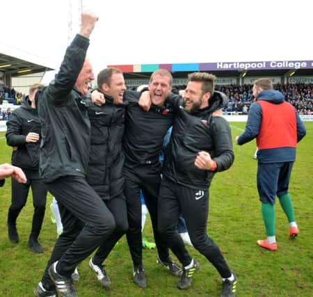 Ronnie Moore (left) and Sam Collins (second from left) celebrate Pools' great escape in 2015. Picture by Frank Reid