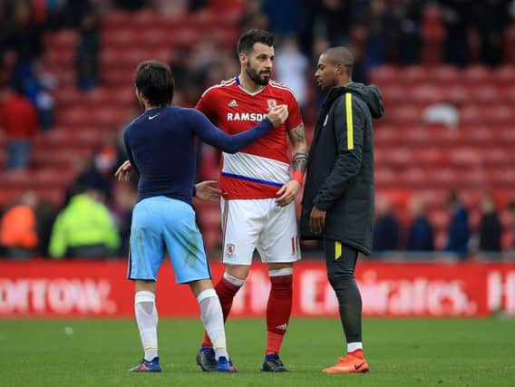 Middlesbrough's Alvaro Negredo (centre) with Manchester City's David Silva (left) and Manchester City's Fernandinho (right) after the final whistle during the Emirates FA Cup quarter final at the Riverside Stadium