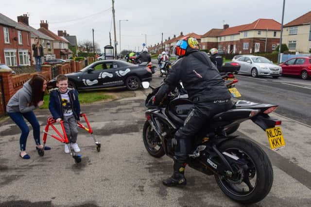 Alfie and his mum Annie watch as members of the North East Bikers arrive at his aunty's house in Blackhall Rocks on Saturday