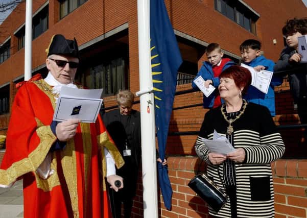 The Mayor of Hartlepool Councillor Rob Cook  making his speech during the Commonwealth Day celebration and flag raising outside of the Civic Centre as and his Mayoress and wife Brenda looks on.