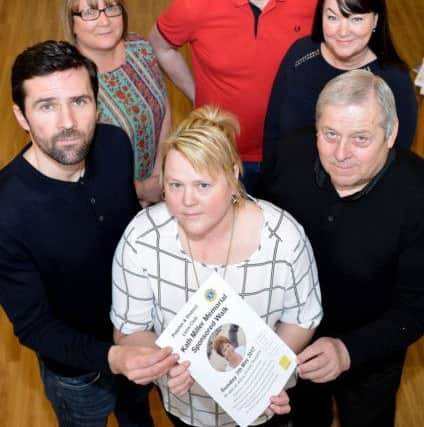 Holding a photograph of Kath Miller are (left to right) son Tommy, Daughter Mandy and husband Tommy, with Hartlepool and district Hospice staff (rear left to right) Bev Playfor, Greg and Julie Hildreth. Picture by FRANK REID