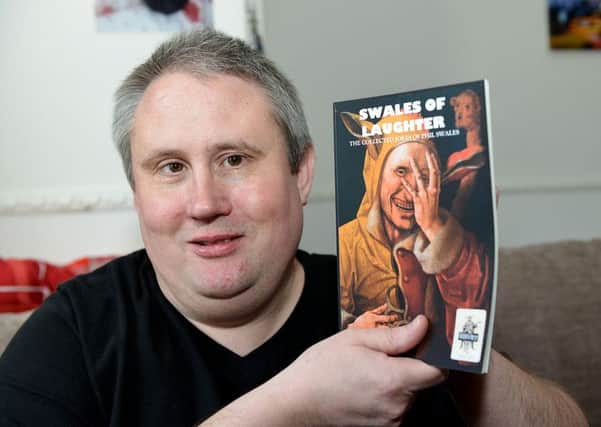 Author Phil Swales with a copy of his comedy book. Picture by FRANK REID