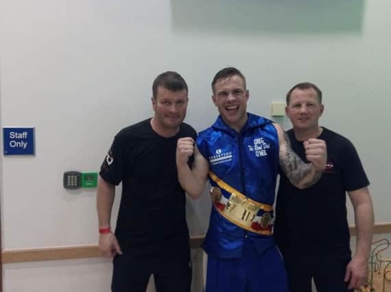 Head coach Peter Cope (left) and coach Alan Temple (right) with triumphant boxer Greg O'Neil.