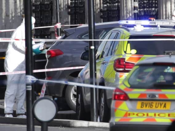 Police forensic officers close to the Palace of Westminster, London, after policeman has been stabbed and his apparent attacker shot by officers in a major security incident at the Houses of Parliament. Pic: PA.