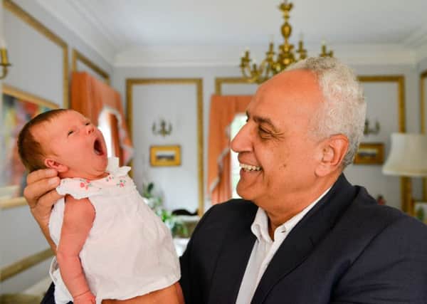 Dr Mohamed Menabawey meeting baby Elodie Meggs who he called his his first IVF grandchild.