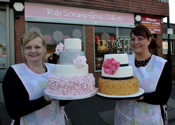 Vicky Gibson (left) with her sister Adele Pidd outside of their Park Road cake shop Truly Scrumptious.