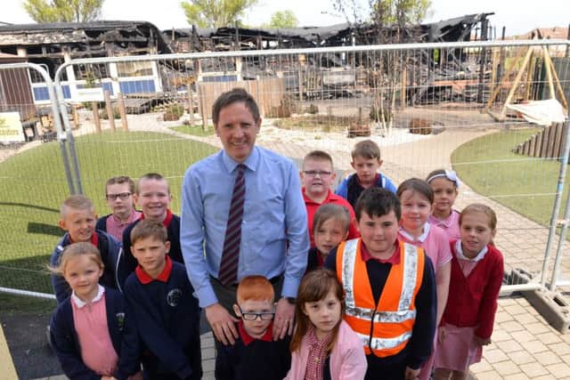 Rift House Primary School pupils have returned to school following Sunday's fire. Pictured are some of its children with headteacher David Turner.