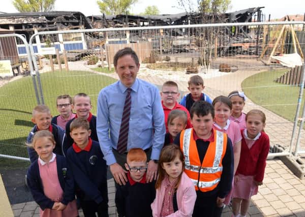 Rift House Primary School pupils have returned to school following Sunday's fire. Pictured are some of its children with headteacher David Turner.