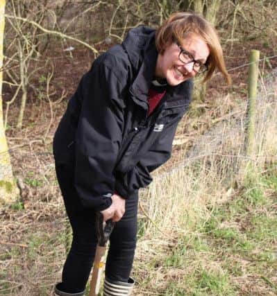 Reverend Gemma Sampson planting a sapling at Summerhill.