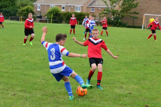 Throston Primary School (red) and Greatham Primary School (blue/white) held a charity football match in aid of Alfie Smith, pictured with football in front row, at Throston Primary on Friday.
