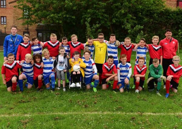 Throston Primary School (red) and Greatham Primary School (blue/white) held a charity football match in aid of Alfie Smith, pictured with football in front row, at Throston Primary School.