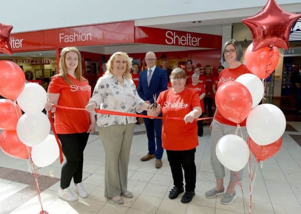 Manager of the Shelter shop Alison Wicks-Jones (2nd left) and volunteer Debbie Cooper cut the ribbon to open the Shelter charity shop at Middleton Grange Shopping Centre, Hartlepool as (left to right) Lisa Coupland (volunteer) Mark Rycraft (shopping centre manager) and Debbie Day (volunteer) along with staff look on. Picture by FRANK REID