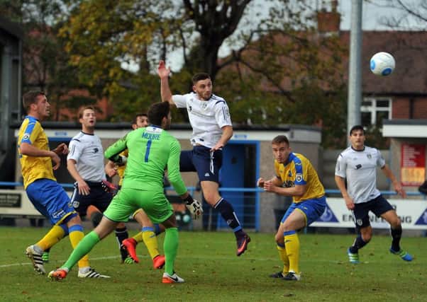 Jake Cassidy powers in a goal for Guiseley against Torquay last season. Picture Tony Johnson.