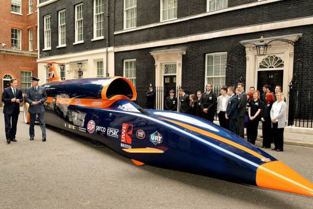 Andy Green shows former Prime Minister David Cameron around the Bloodhound on a visit to downing Street in 2013.