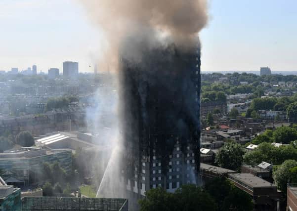 Smoke billows from a fire that has engulfed the 24-storey Grenfell Tower in west London.  PRESS ASSOCIATION Photo. Picture date: Wednesday June 14, 2017. More than 200 firefighters were sent to tackle the blaze and London Ambulance Service said 30 people had been taken to five hospitals. See PA story FIRE Grenfell. Photo credit should read: Victoria Jones/PA Wire