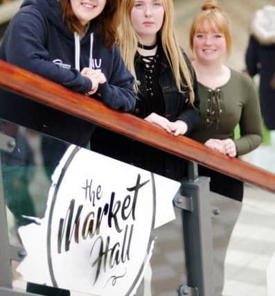 Hartlepool College of Further Education students, from left to right, Ashleigh Humble, Robyn Hart and Danielle O'Neill with the Market Hall logo.
