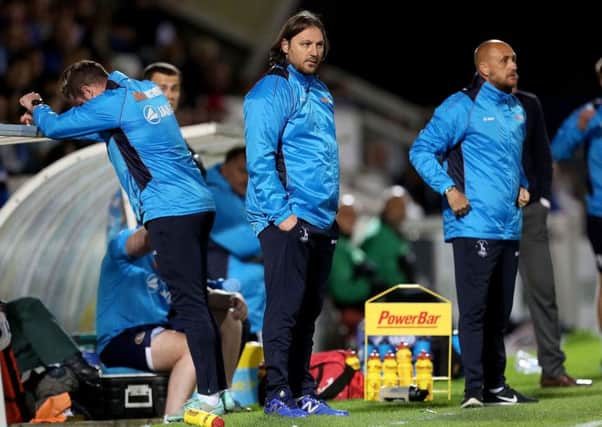 Hartlepool United manager Craig Harrison looks on from the sidelines.