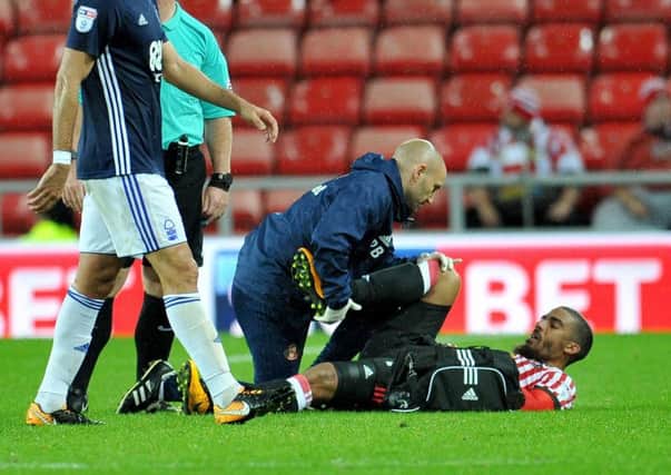 Lewis Grabban is treated for his injury.