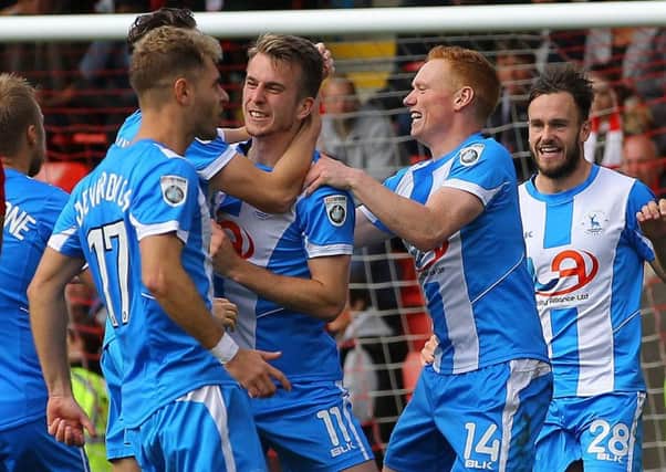 Rhys Oates is mobbed after scoring Pools' winner at Leyton Orient.
