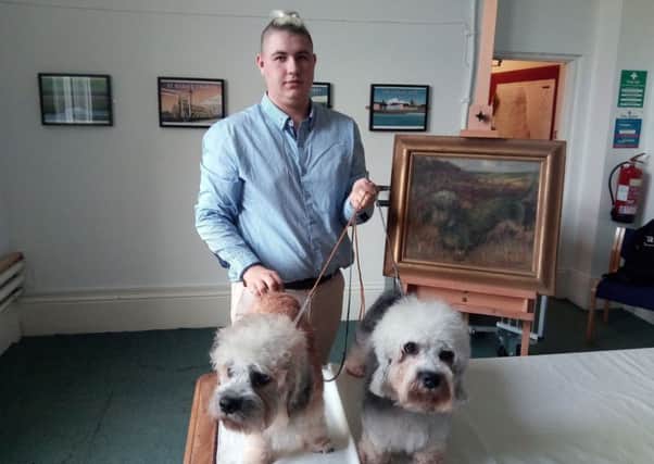 Alexander Garratt with his rare Dandie Dinmont Terriers alongside the John William Howey painting 'The Terrier Dog'.