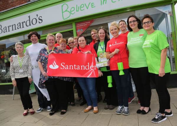 Staff from Santander bank running Barnardos shop for a day in Store Wars competing against other branches. Picture: TOM BANKS