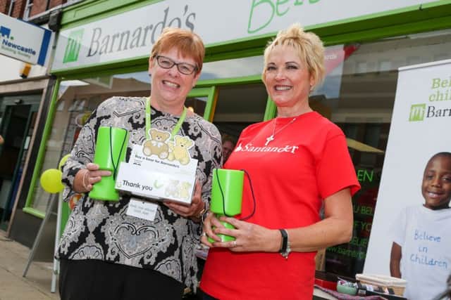 Staff from Santander bank running Barnardos shop for a day in Store Wars competing against other branches. Pictured are Barnardo's shop manager Karen Scott and Santander manager Janet Watkins. Picture: TOM BANKS