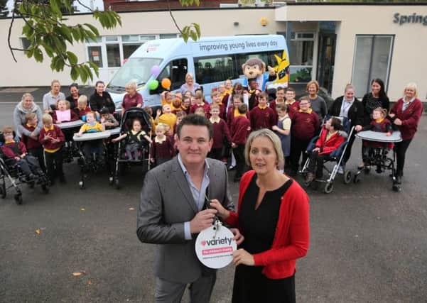 Paul Gough hands over the keys of a new mini bus on behalf of the Variety Club GB to ZÃ¶e Westley, head teacher of Springwell School, Hartlepool. Picture: TOM BANKS