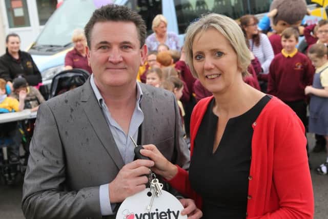 Paul Gough hands over the keys of a new mini bus on behalf of the Variety Club GB to ZÃ¶e Westley, head teacher of Springwell School, Hartlepool. Picture: TOM BANKS