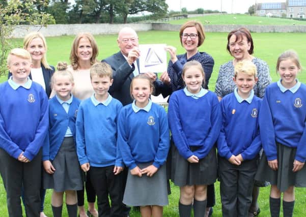 Colin Reid and Jo Heaton display the Governor Mark award with governors Phillipa Dickson and Katy Hill and Ann Turner, the councils Governor Services Manager. Front row are pupils Ben Taylor, Annabelle Myers, Cian Tomlin, Freya Pounder, Lily Noble, Ryan Hedley-Price and Carys Stoker.