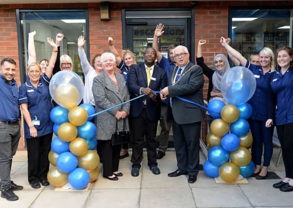 The Mayor of Hartlepool Councillor Paul Beck opens the new Victoria Pharmacy with a helping hand from his wife Mary who is the Mayoress and pharmacy manager Philip Obomighie as staff celebrate its opening. Picture by FRANK REID