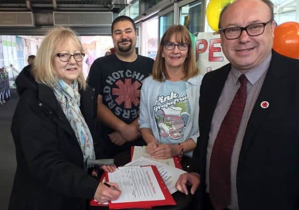 Grahame Morris MP (far right) and Peterlee councillor Louise Fenwick (second right) with people signing a petition calling a temporary library in Peterlee.